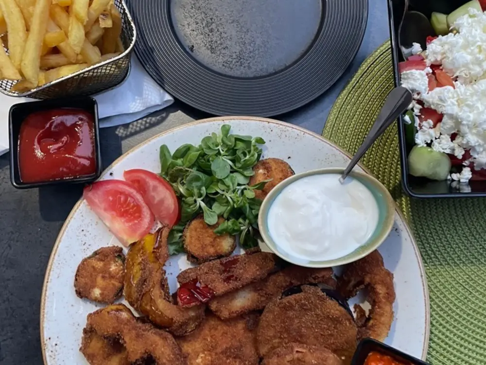 Ein Grillteller mit Pommes und Schafskäse als Beilage von XxXL Grill Restaurant in Ottakring.
